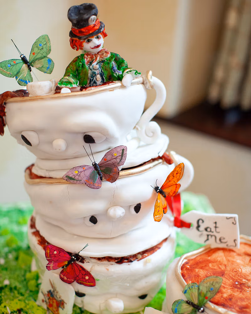 Leeds Wedding Photographer captured a photo of a Mad Hatter wedding cake. Caught just before it started to fall