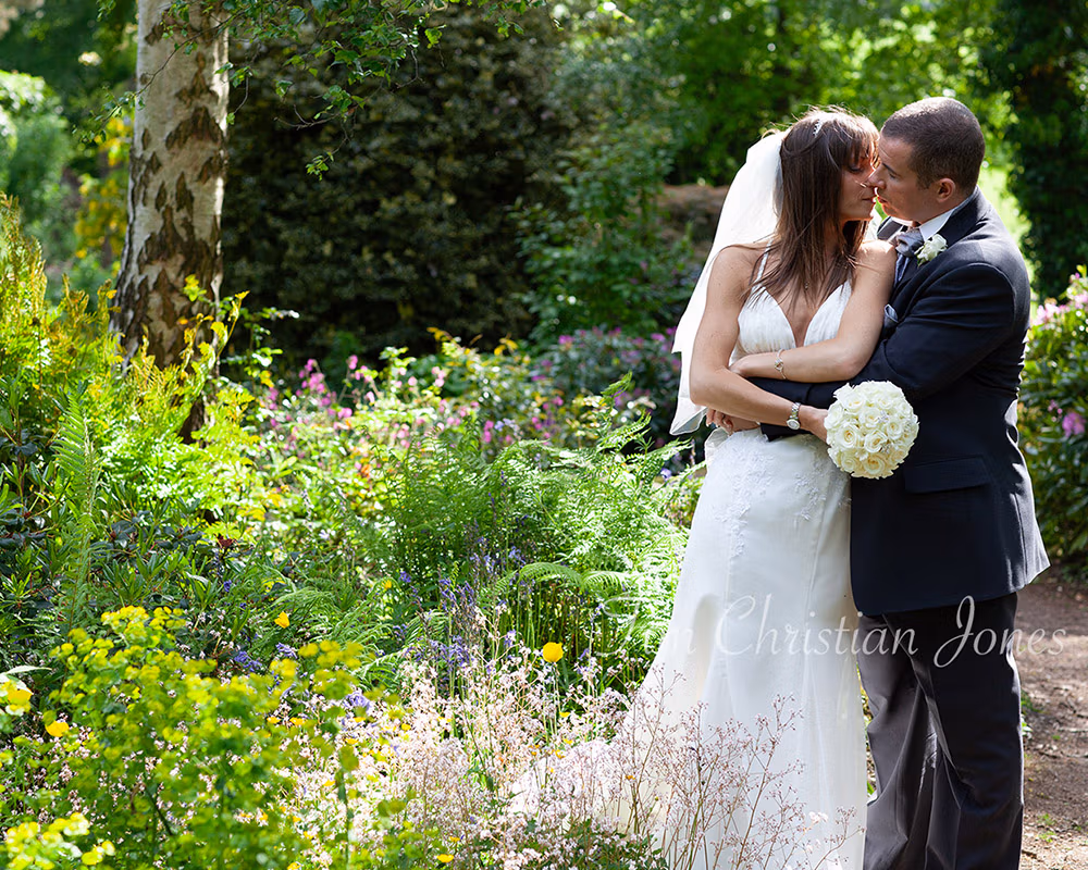 Couple portraiture in a hidden floral garden in a Yorkshire wedding near Leeds photographed by Tim Christian Jones