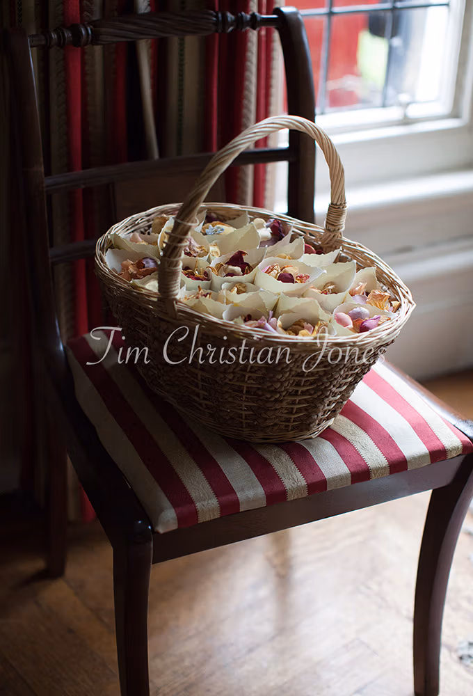 Bridesmaid's flower basket on a striped chair in the bridal suite