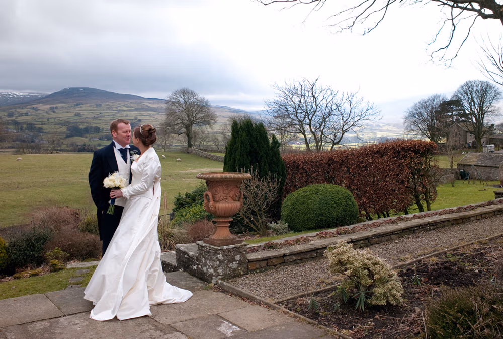 Alison and Hamish posed in the February light after their Simonstone Hall wedding ceremony.