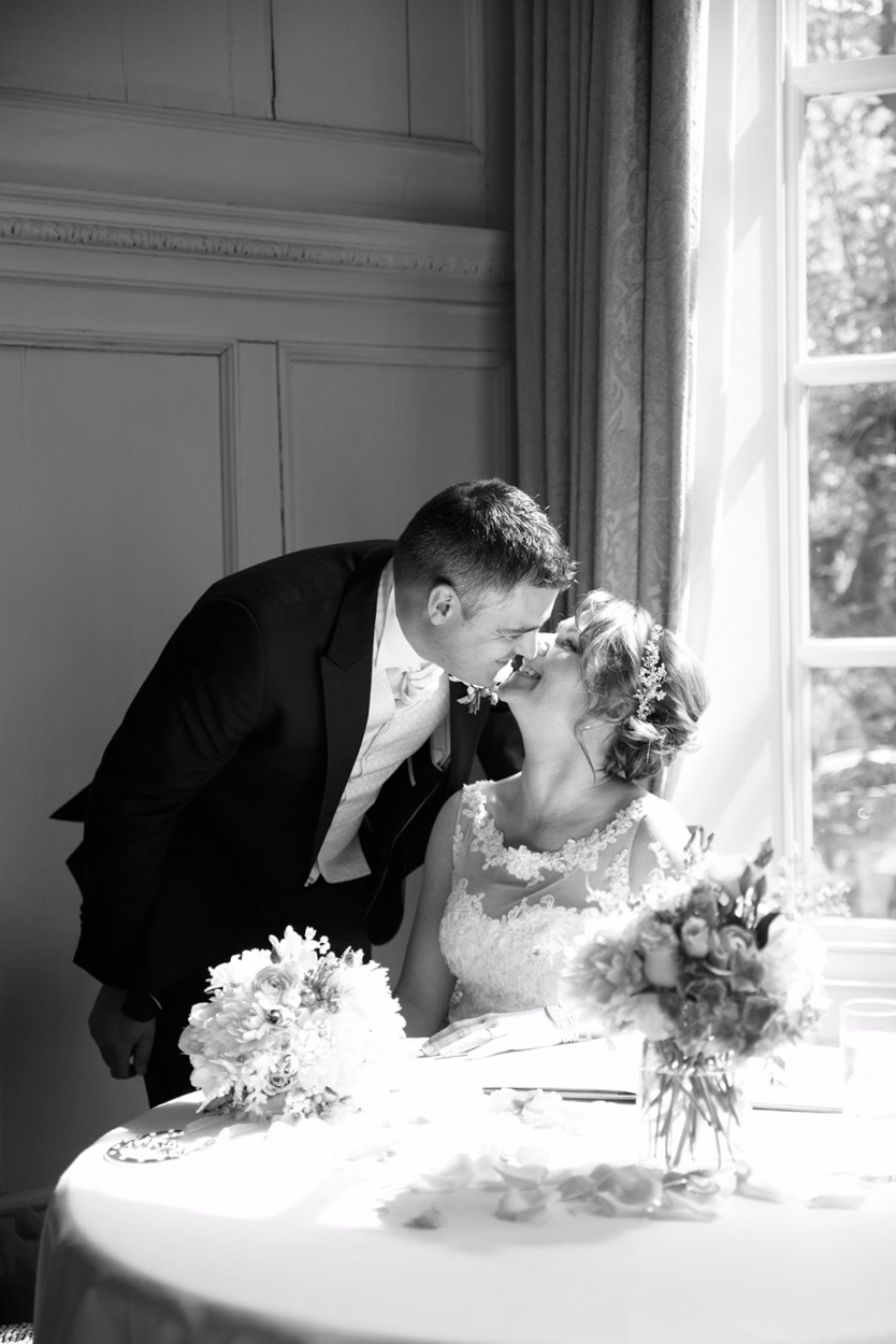 Grays Court Hotel York Wedding - The couple kiss in monochrome during the wedding ceremony