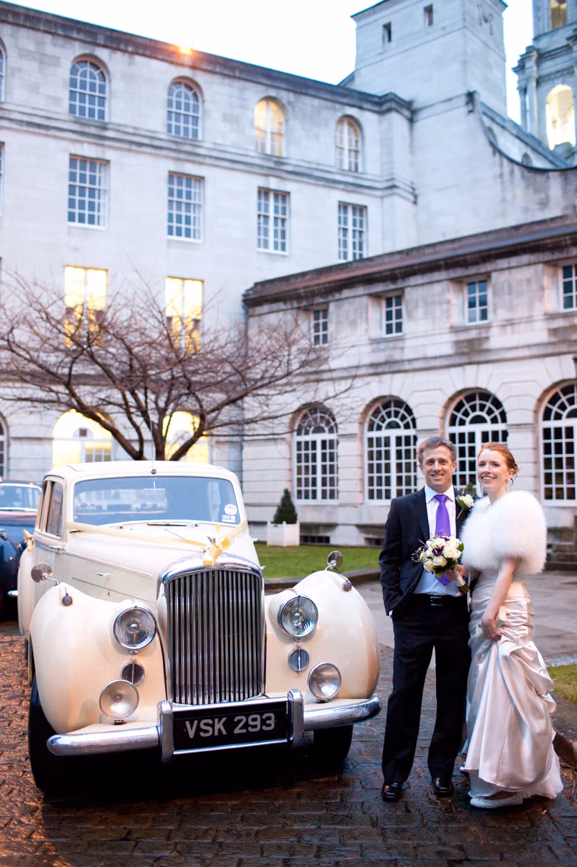 A Leeds Civic Hall Wedding moves onto Headingley Stadium - Sarah & Mark alongside their wedding car.