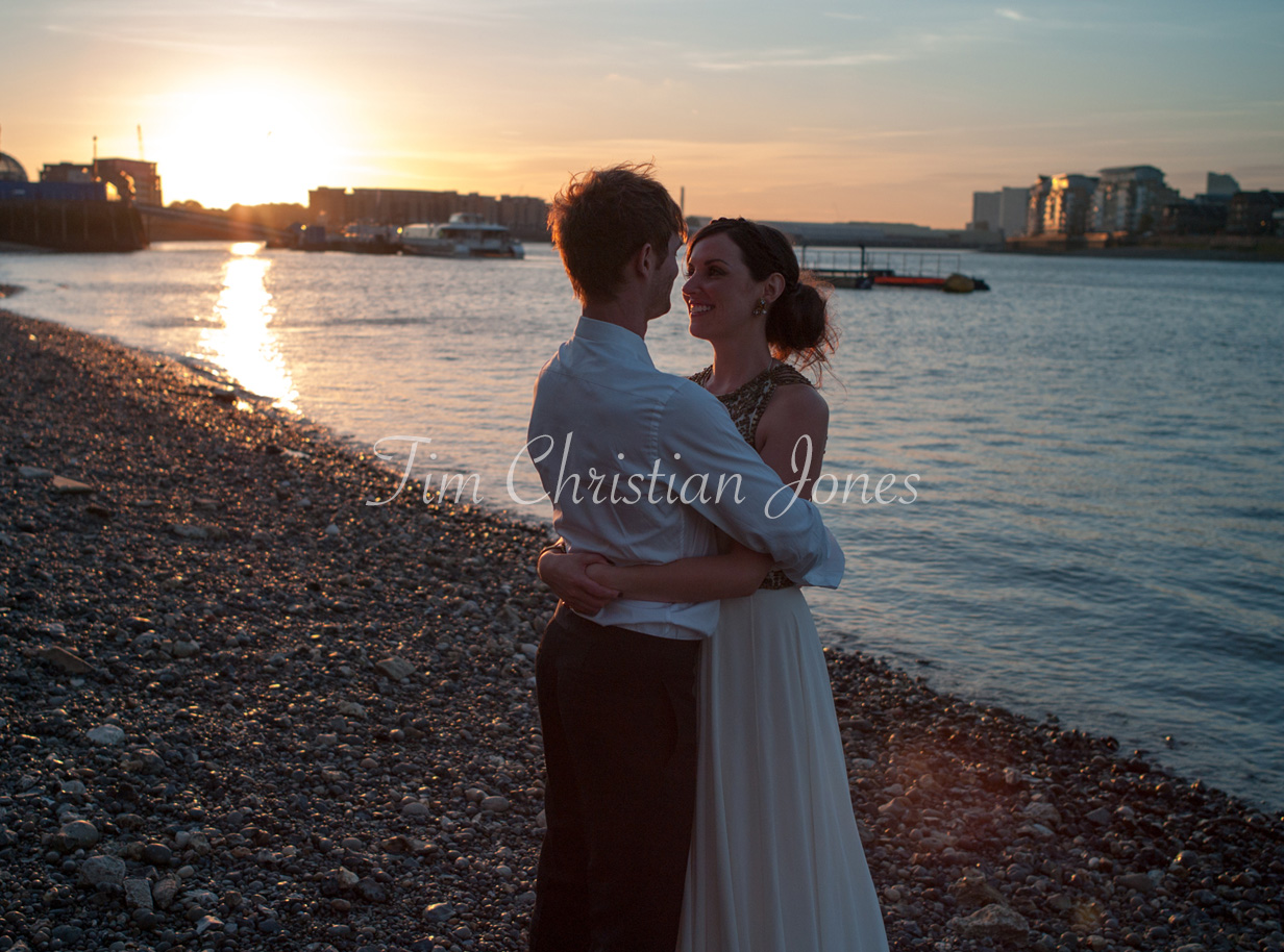 Kat & Jamie sharing a quiet moment together on the pebble shore of the River Thames outside the Trafalgar Tavern in Greenwich at sunset.