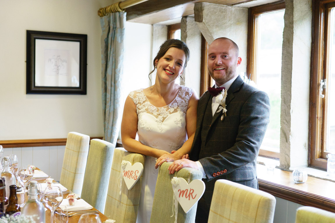 Kat and Mark by the wedding breatfast top-table in the Country Room at The Woodman Inn, Huddersfield, by Tim Christian Jones