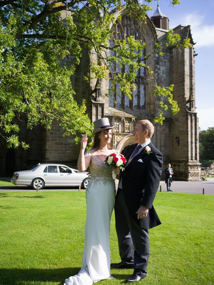 Candid couple portrait outside Bolton Priory Yorkshire wedding setting