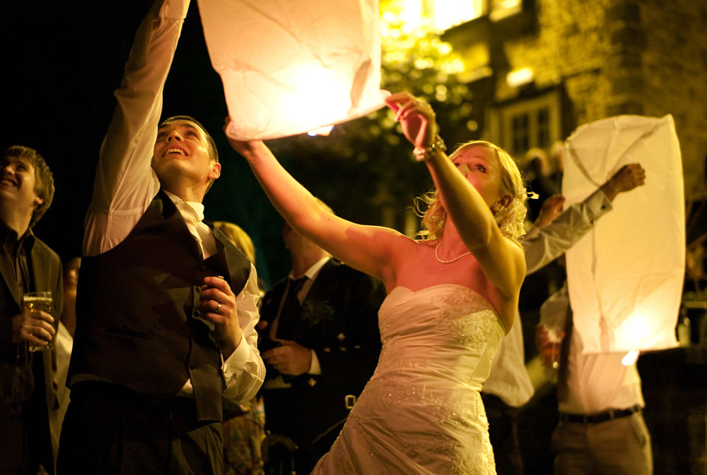 Dani and Scott release a Chinese lantern into the night sky at their April Hoyle Court wedding