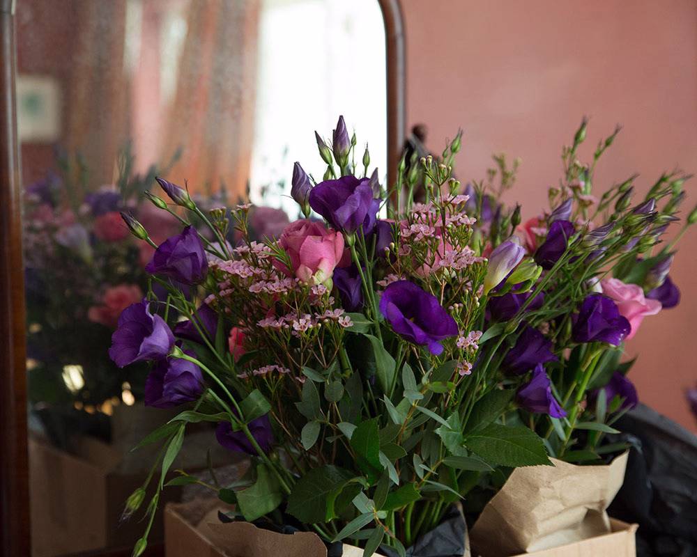 Autumn colours - a wedding bouquet beside a vintage mirror. An October wedding photographed by a passionate wedding photographer based in Leeds, West Yorkshire.