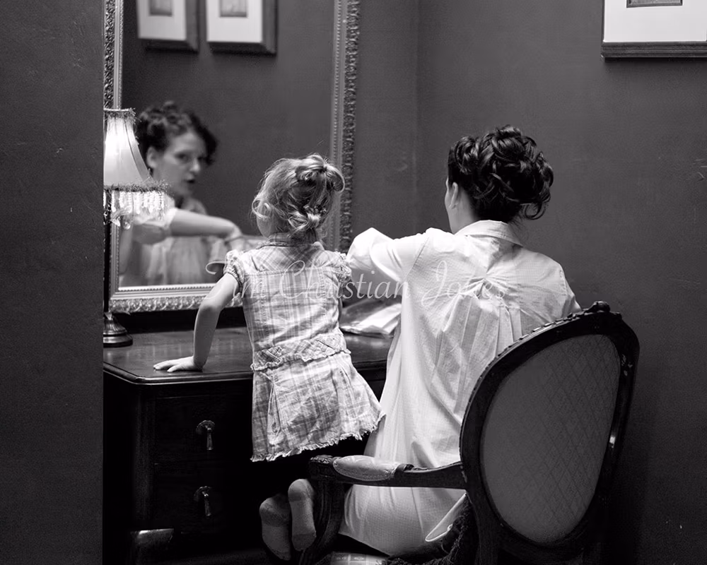 Preparation moments in monochrome by a Leeds wedding photographer - The bride and her daughter by the mirror in the bridal suite