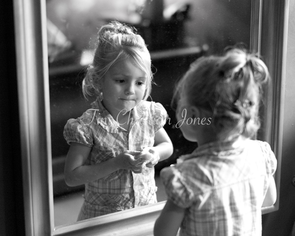 Bride's daughter, quiet concentration on her face - looking into the mirror as she applies lip gloss