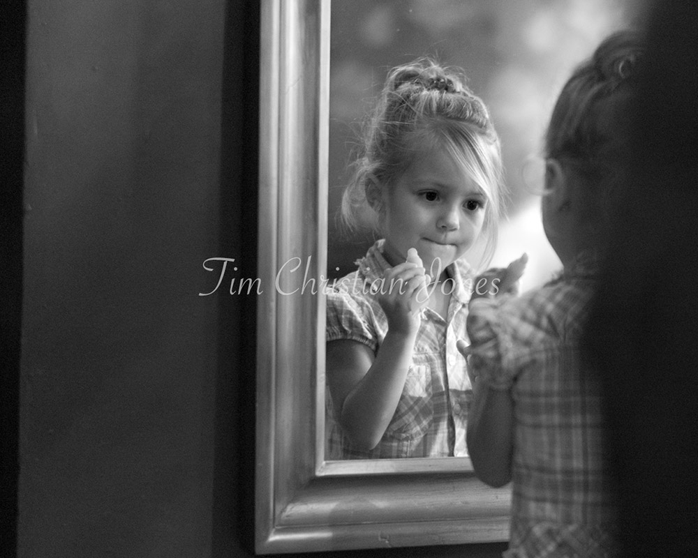 The bride's daughter now alone finishing her makeup - cute and timeless moments captured by a Leeds wedding photographer - Tim Christian Jones