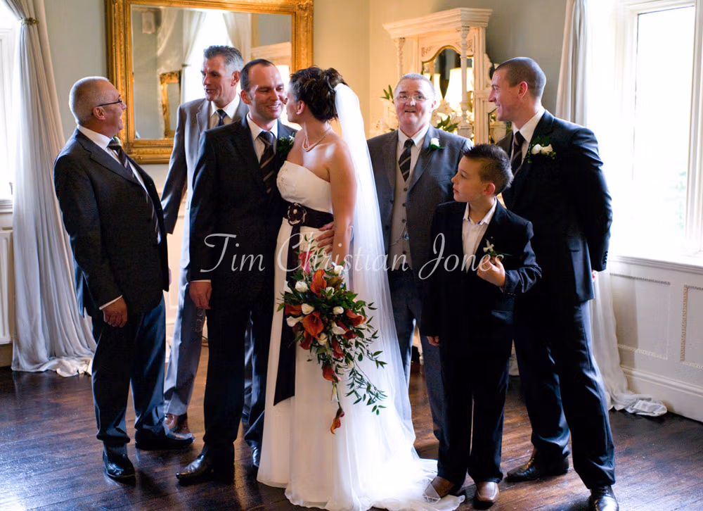 A candid family group shot filled with natural smiles and playful conversation.