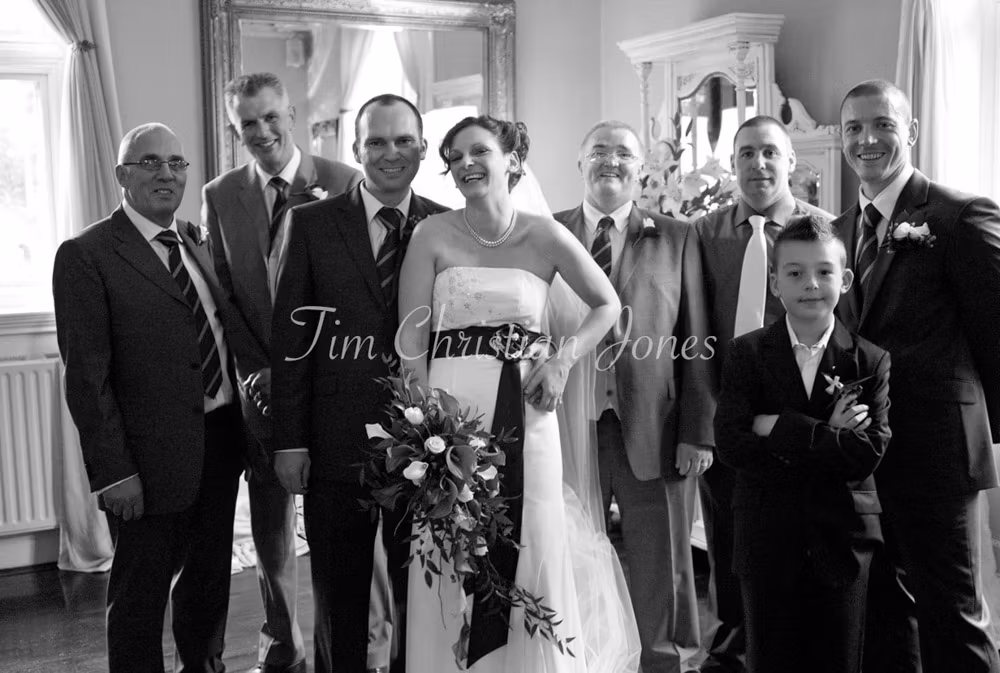 The family turns toward the camera with open, easy smiles after the laughter.