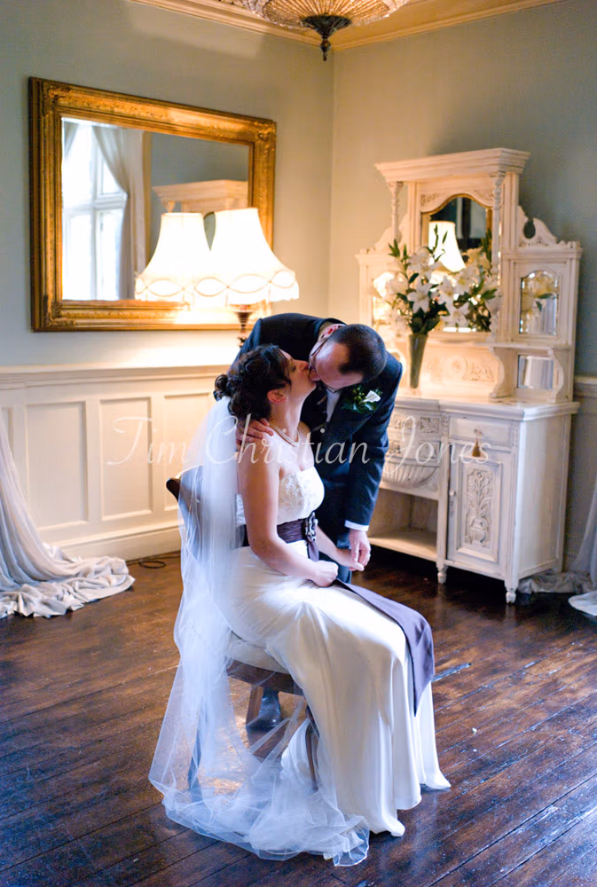 Julie and Pat in the same position, now caught in colour as they lean in for a kiss.