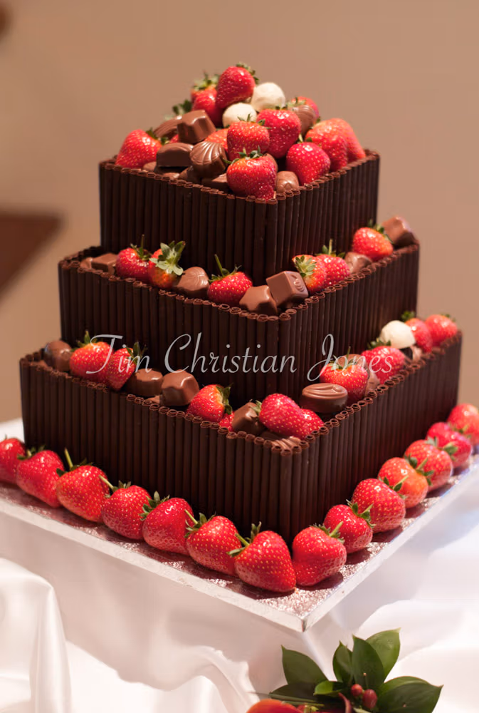 Close-up of the wedding cake — chocolate layers with fresh strawberries, beautifully simple.