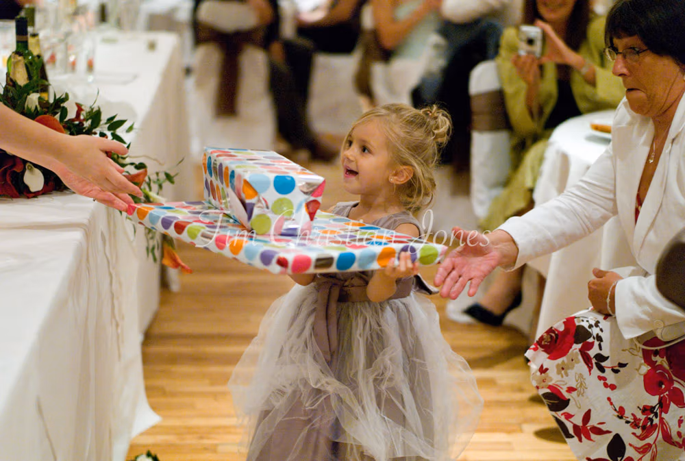 Julie and Pat’s daughter beams as she receives a surprise gift during the speeches.
