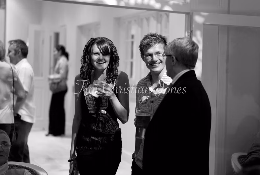 Guests share smiles and stories, relaxed in the warm evening atmosphere.