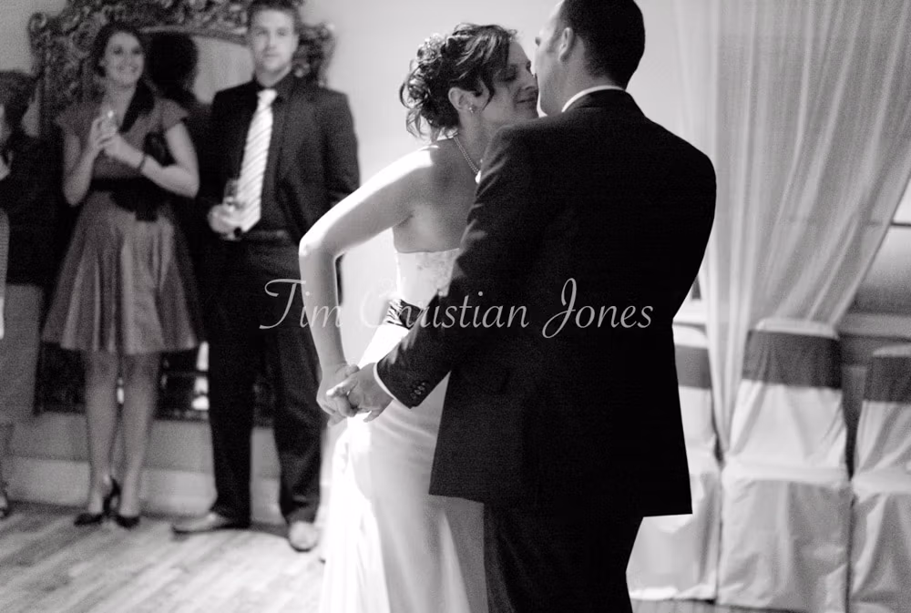 Midway through the dance, the couple slow and lean into a kiss under the soft lights.
