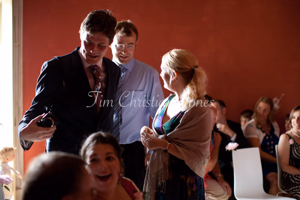 Wedding guests seated and chatting inside the Temple of Apollo before the ceremony