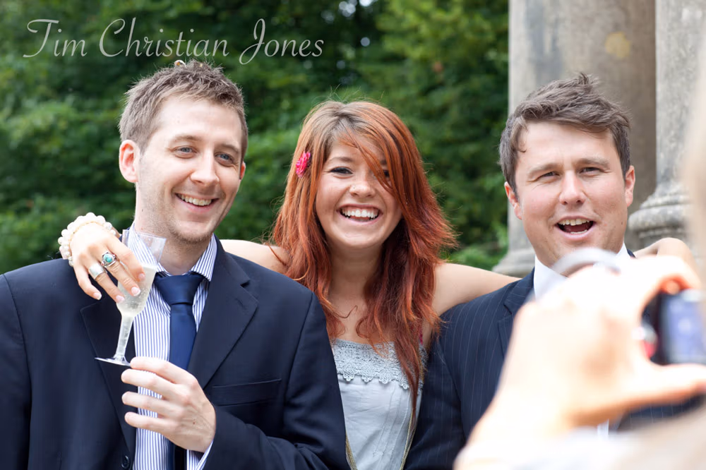 Natural group photos taking place casually among wedding guests