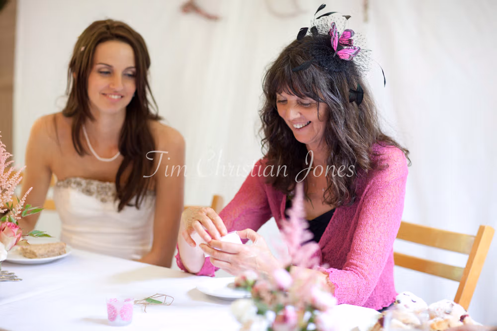 Bride and her mum smiling together during a relaxed West Yorkshire wedding reception
