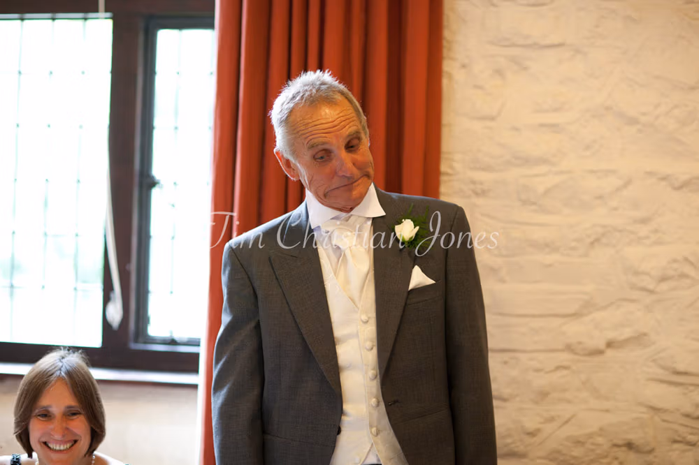 Close-up of the father of the bride smiling with pride
