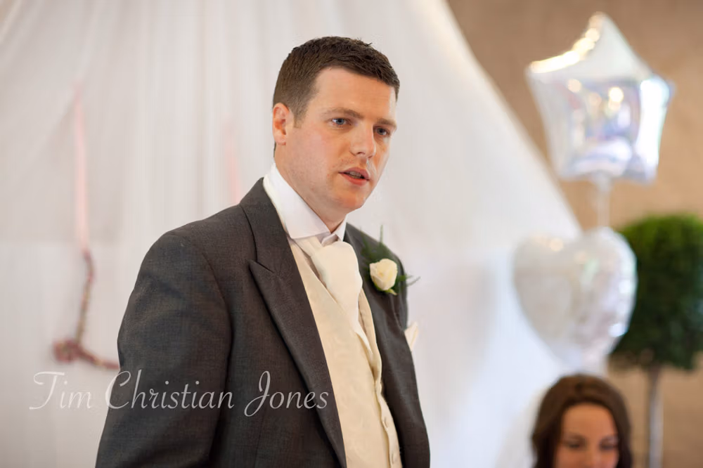 Groom Tim begins his wedding speech at the top table