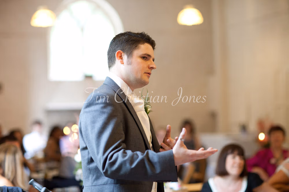 Best man using expressive gestures as he begins his speech