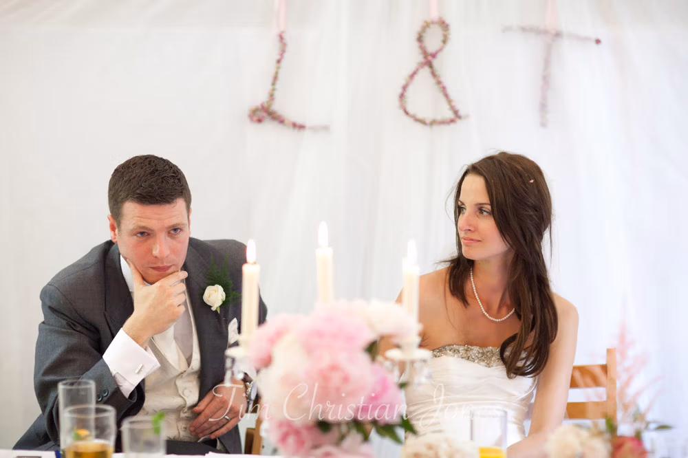 Lowri gazes at Tim with gentle empathy during the speeches