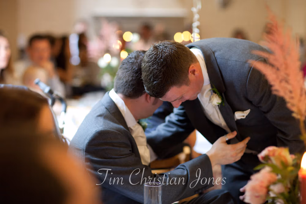 Groom Tim hugging the best man warmly after the speech