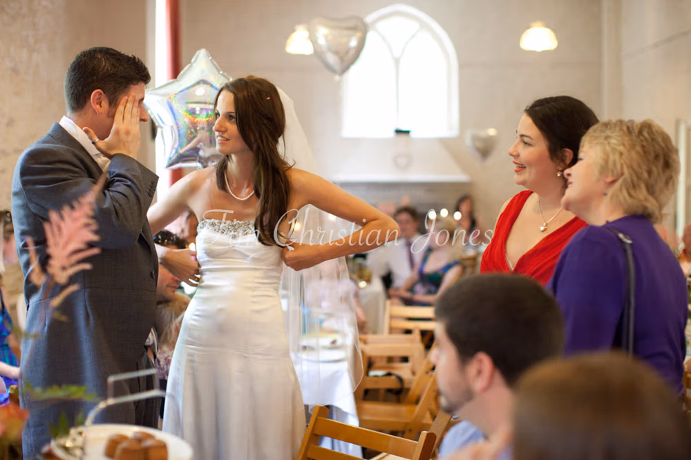 Lowri speaking with the best man while others smile around them