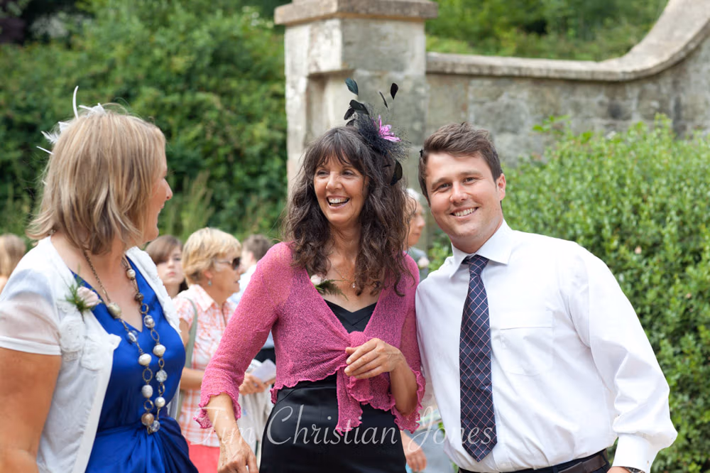 Bride’s brother, mum and a close friend standing together outside