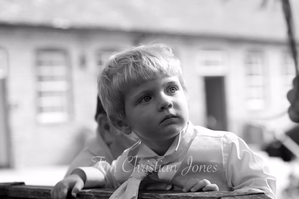 Black and white photo of the couple’s son, looking thoughtful