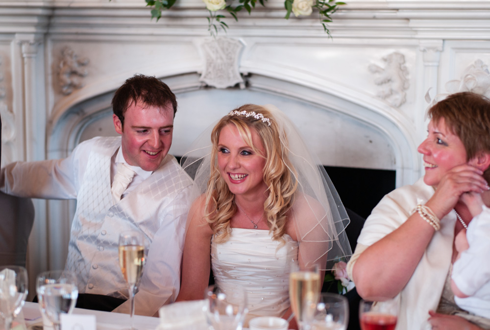Vicky and Lee share happy moments at the Top Table during their Allerton Castle wedding breakfast.