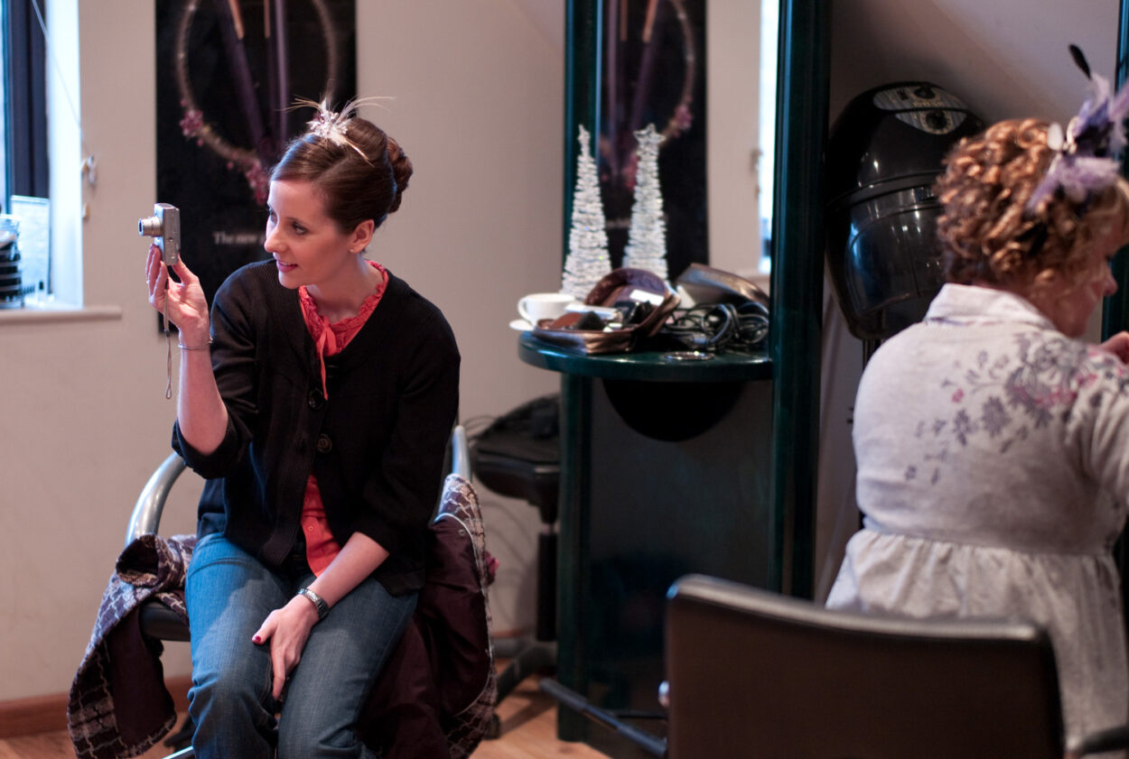 Emelie at the hairdressers taking a photo of her sister while having her hair done.
