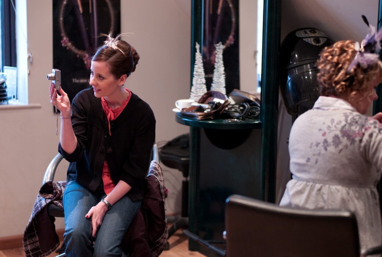 Emelie at the hairdressers taking a photo of her sister while having her hair done.