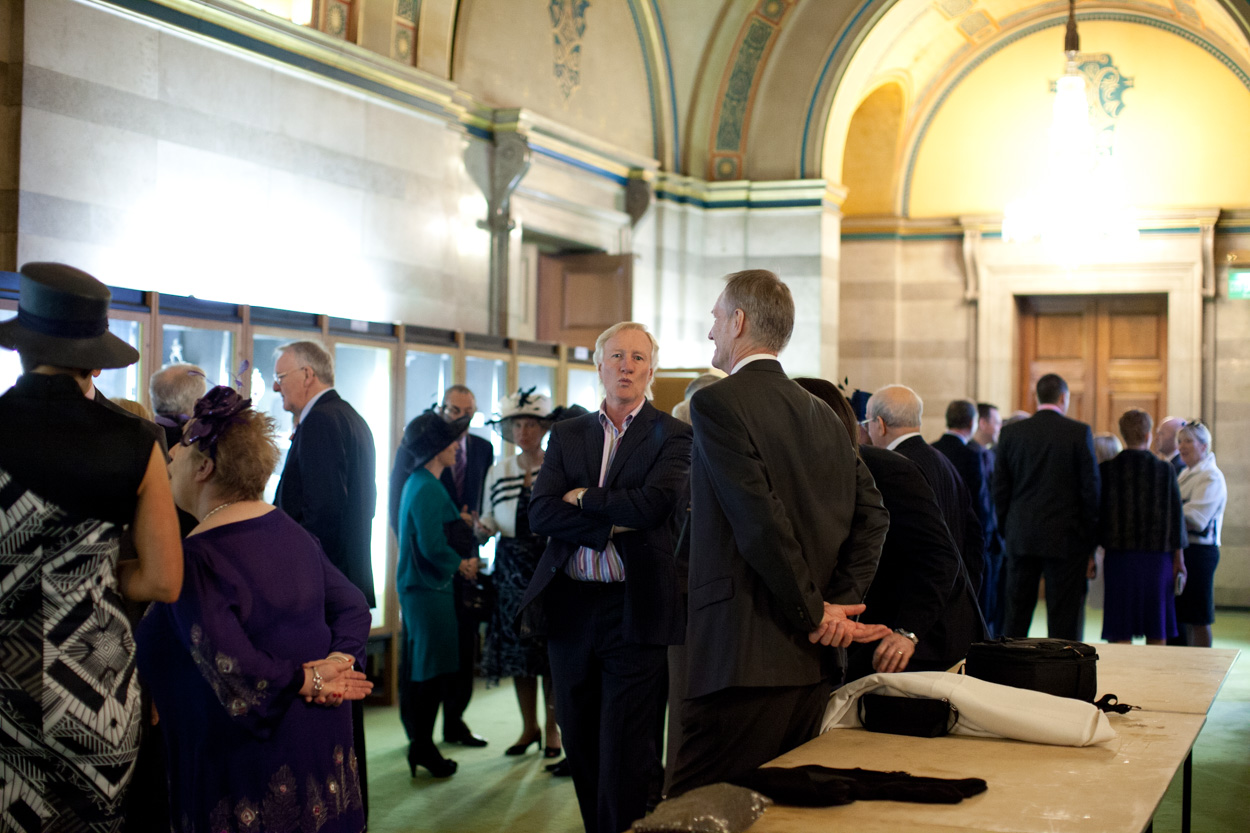 Guests gathering and chatting inside the Great Hall at Leeds Civic Hall before the ceremony.