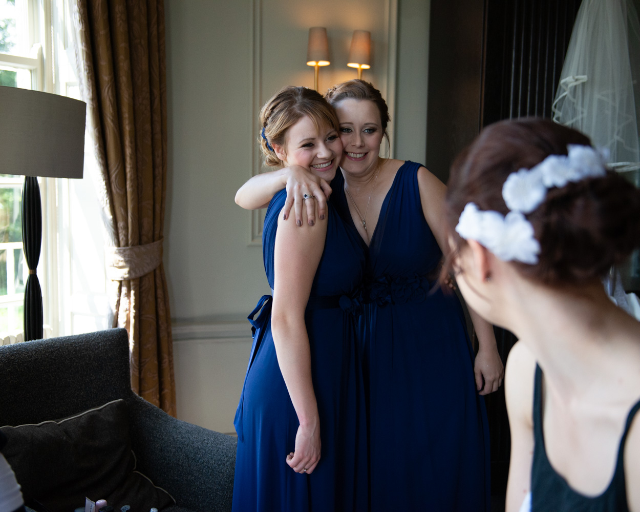 Bridesmaids huddle together as Tanya admires them ready
