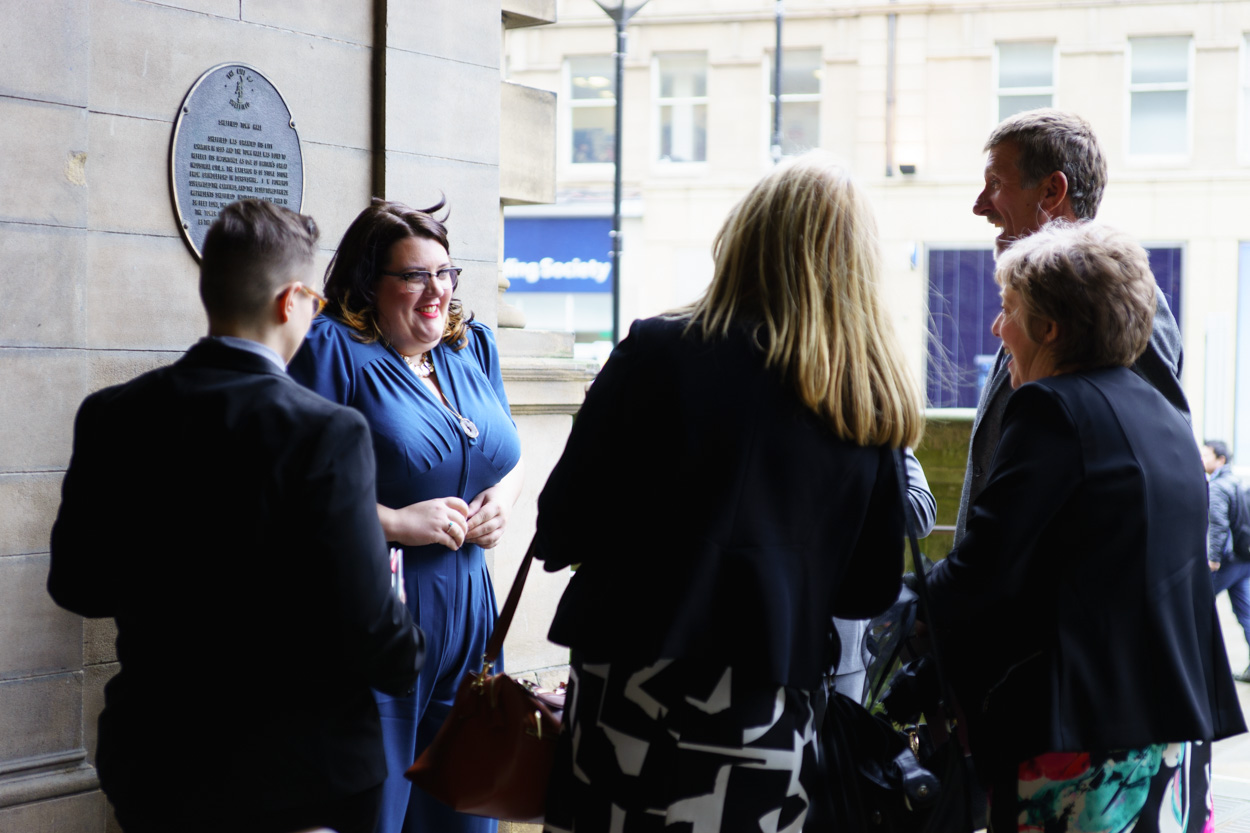 Lizzie and Tamara outside Sheffield Town Hall greeting guests on a chilly spring day