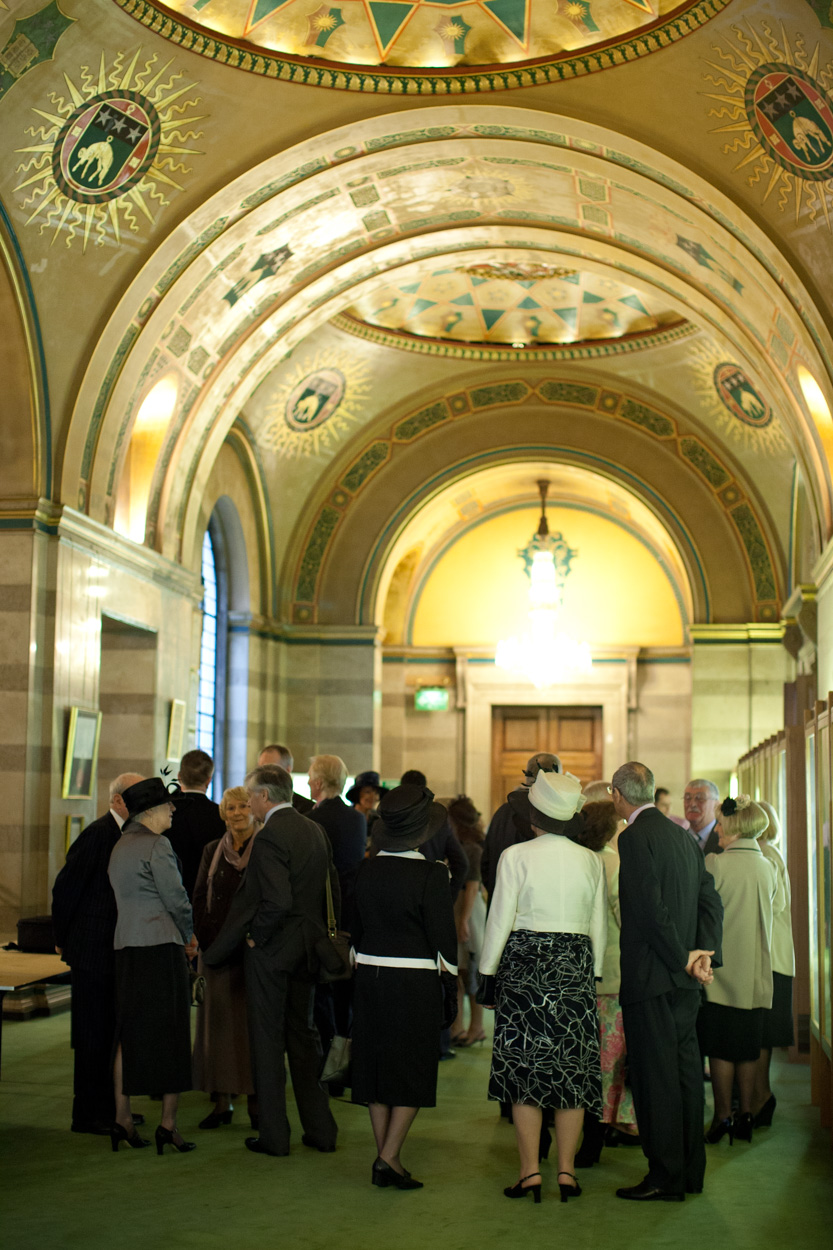 Ornate ceiling details of the Great Hall at Leeds Civic Hall as guests wait below.