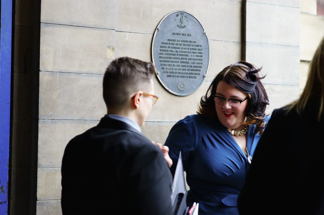 Lizzie gently touching Tamara’s suit before the ceremony