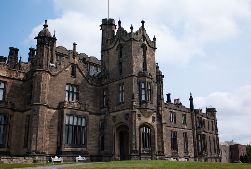 The grand exterior of Allerton Castle under a soft cloudy sky