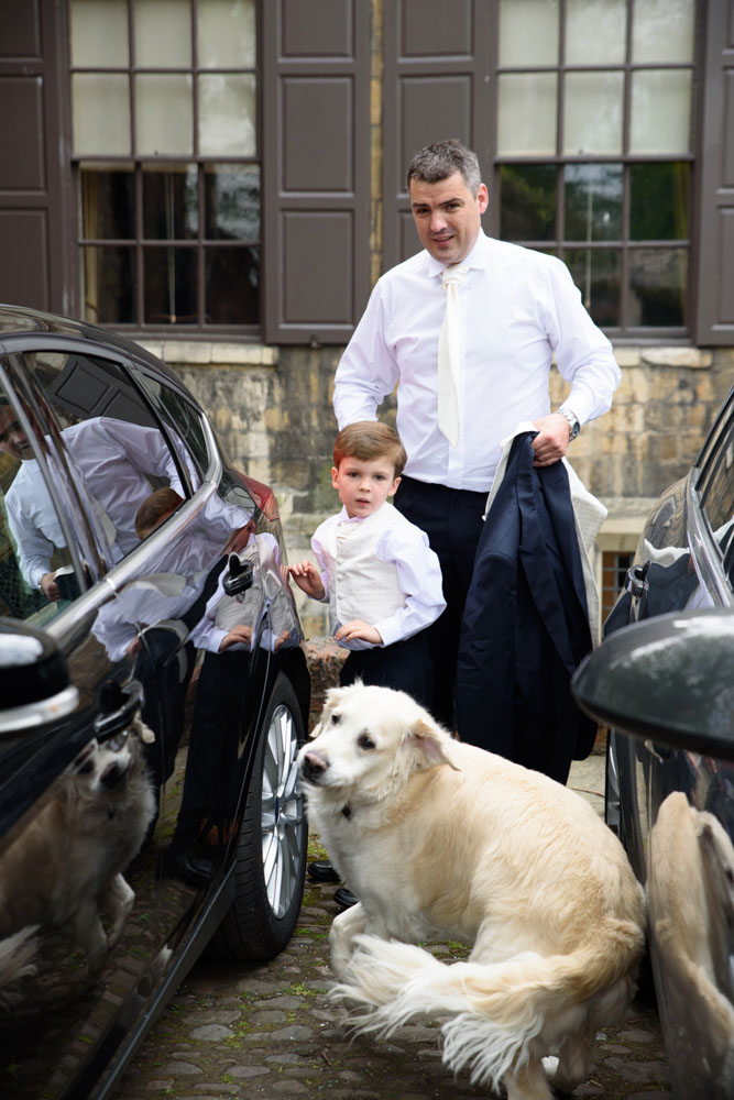 Neal arrives in the car park with his son and their golden retriever.