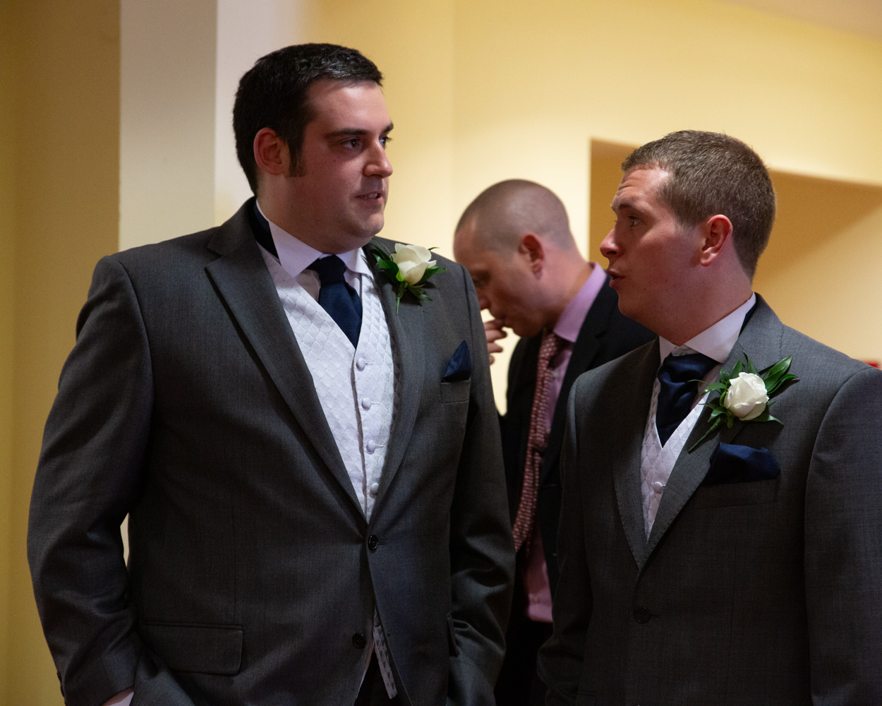 Groom chatting with a groomsman at Scarborough Spa before the ceremony, anticipation and nerves setting in.