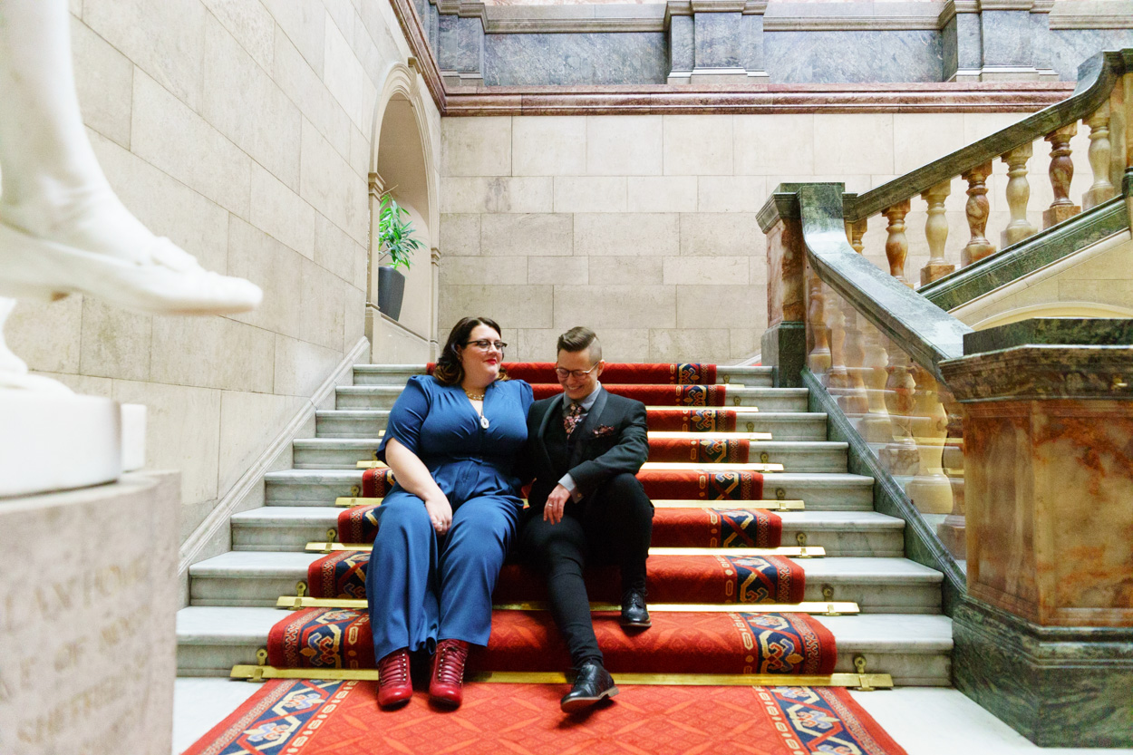 Lizzie and Tamara sitting together on the stairs sharing a proud moment