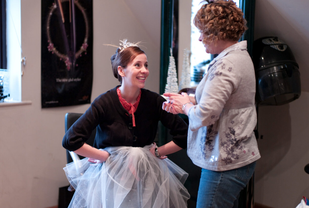 Emelie looks up at her mum with a bright, warm smile.