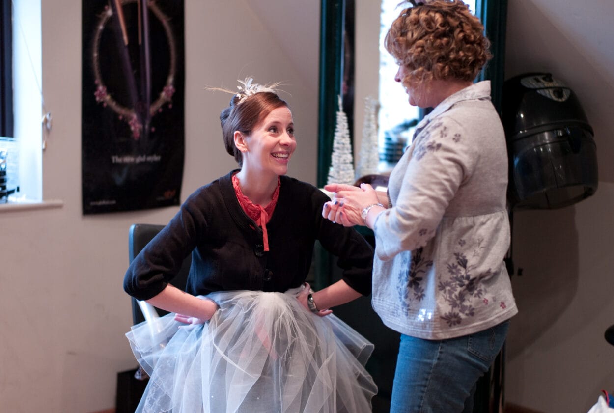 Emelie looks up at her mum with a bright, warm smile.
