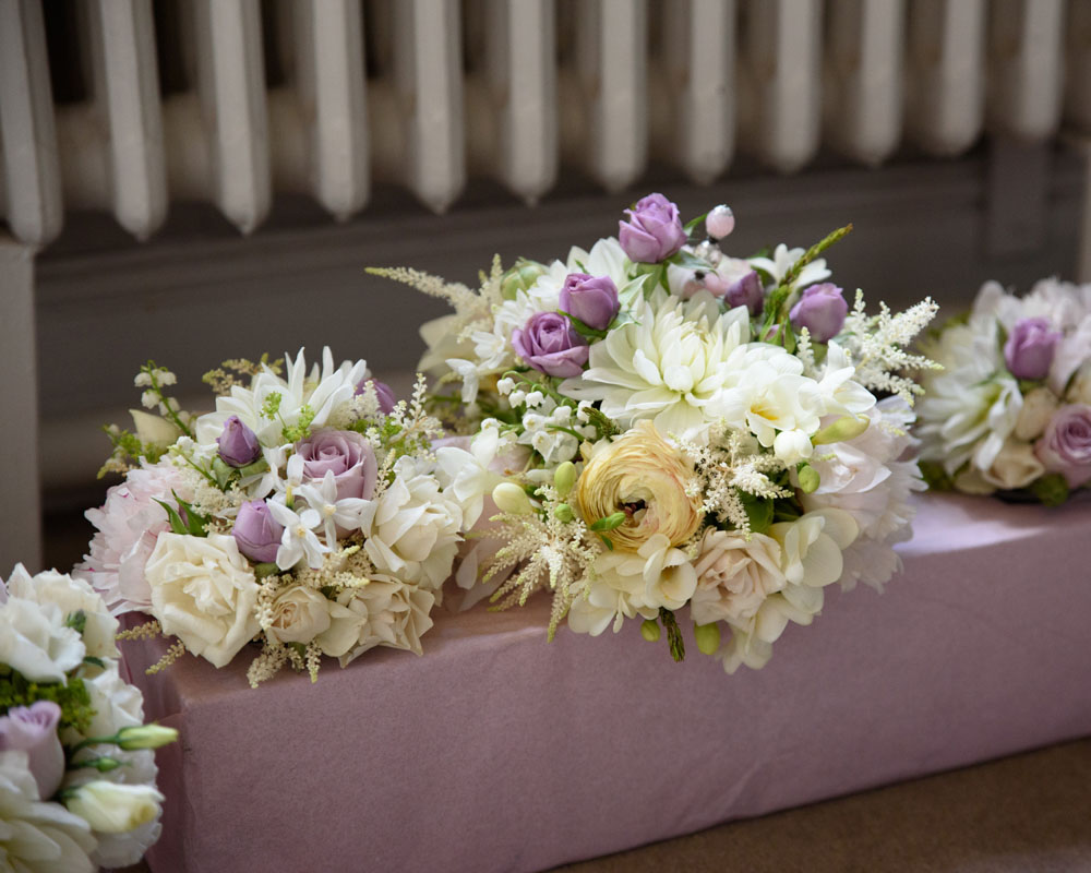 Wedding bouquets arrive, carefully boxed and placed on the floor.