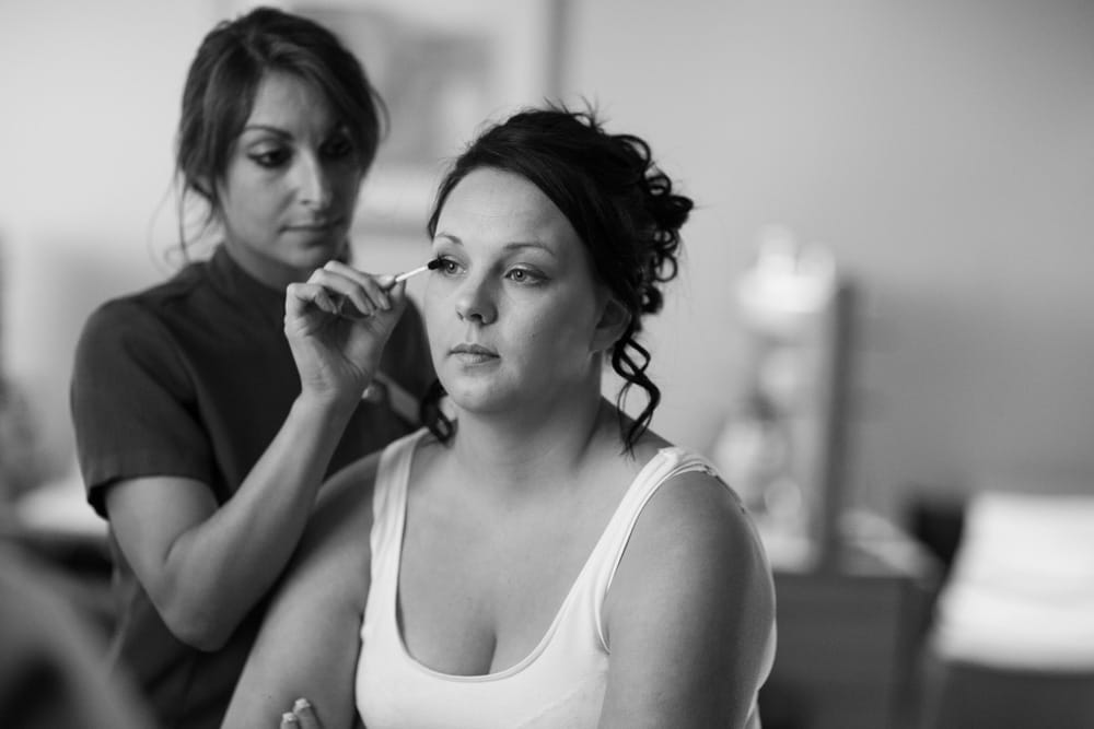 Black and white close-up of Gemma’s eye makeup being applied.