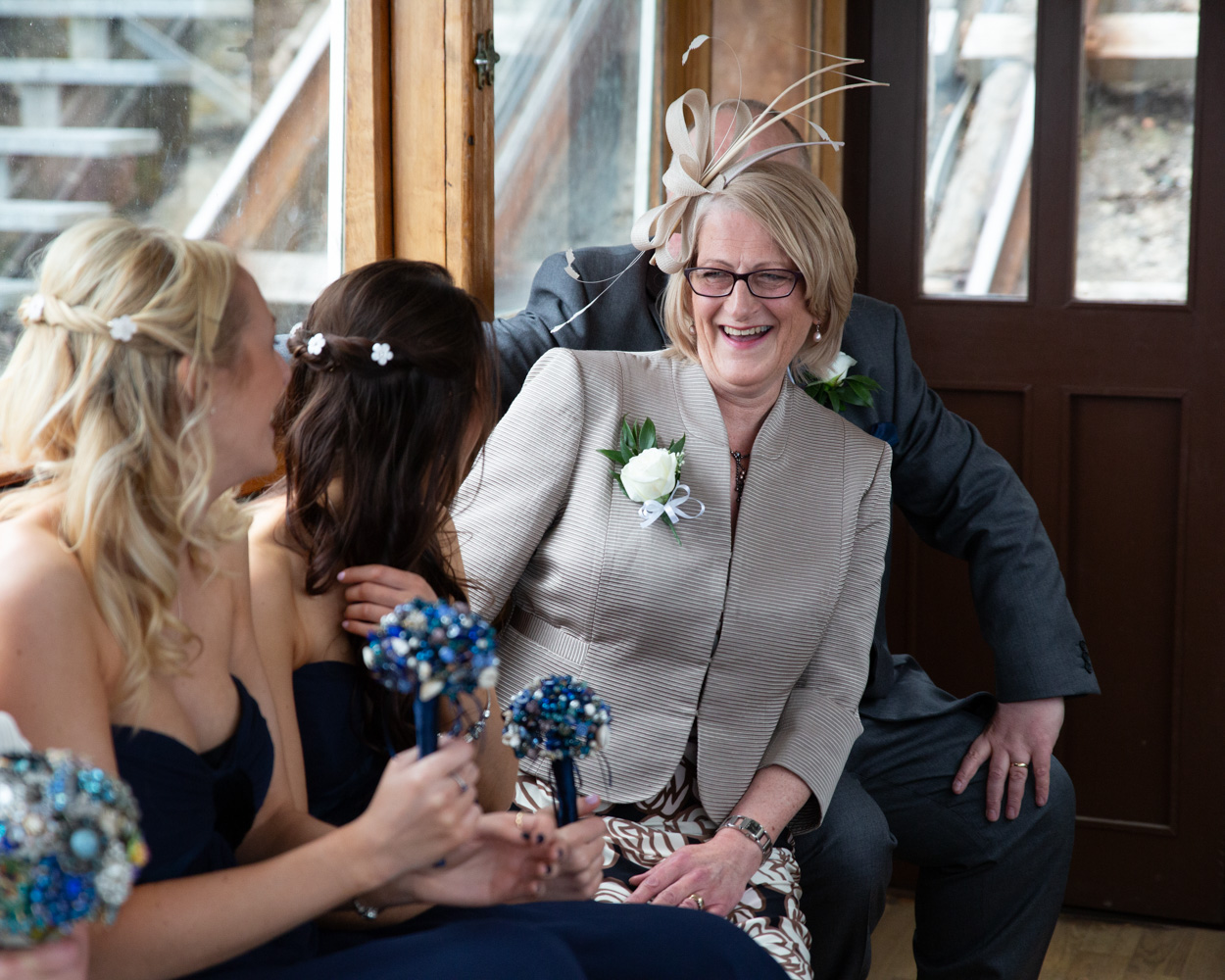 Bride and bridal party riding the Scarborough cliff lift, laughing and enjoying the moment before the ceremony.