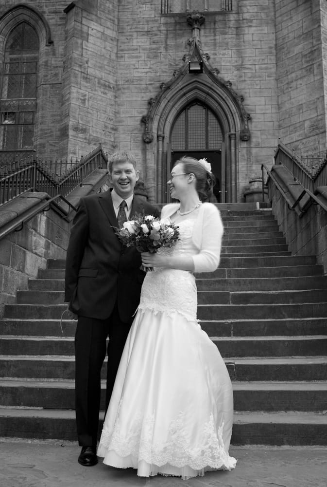Bride and father smiling at each other outside St George’s Church, Leeds.